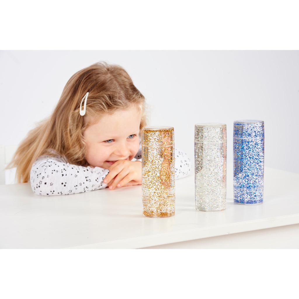 A collection of clear tubes filled with swirling glitter in vibrant colors, designed to provide visual stimulation and calming sensory input.