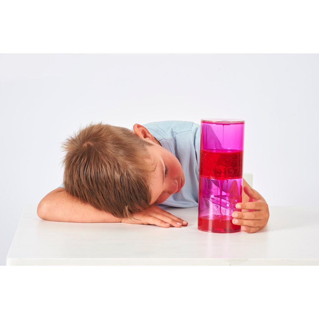 A large, clear tube filled with slow-moving, colorful liquid, designed to captivate attention and support calming sensory experiences.