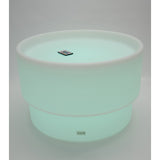 An illuminated LED table with a deep circular well, designed for sensory play, color exploration, and interactive learning activities.