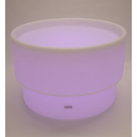 An illuminated LED table with a deep circular well, designed for sensory play, color exploration, and interactive learning activities.
