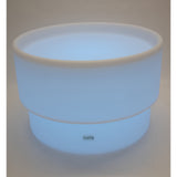 An illuminated LED table with a deep circular well, designed for sensory play, color exploration, and interactive learning activities.