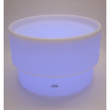 An illuminated LED table with a deep circular well, designed for sensory play, color exploration, and interactive learning activities.