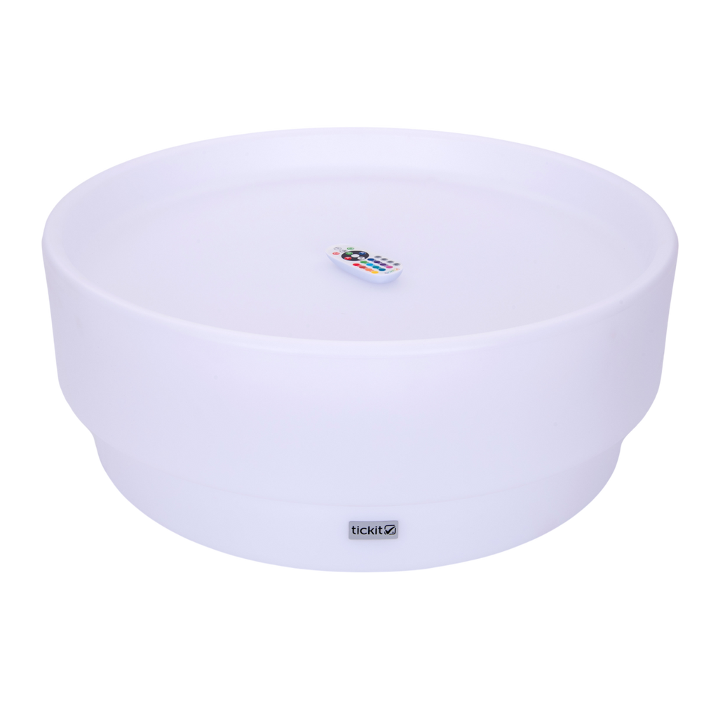 A softly glowing LED table with a shallow well, designed for sensory exploration, water play, and immersive learning experiences.
