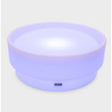 A softly glowing LED table with a shallow well, designed for sensory exploration, water play, and immersive learning experiences.