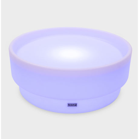 A softly glowing LED table with a shallow well, designed for sensory exploration, water play, and immersive learning experiences.