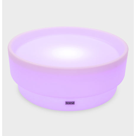 A softly glowing LED table with a shallow well, designed for sensory exploration, water play, and immersive learning experiences.
