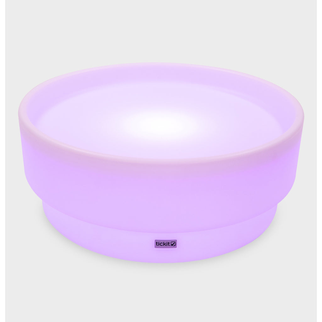 A softly glowing LED table with a shallow well, designed for sensory exploration, water play, and immersive learning experiences.