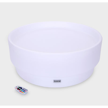 A softly glowing LED table with a shallow well, designed for sensory exploration, water play, and immersive learning experiences.