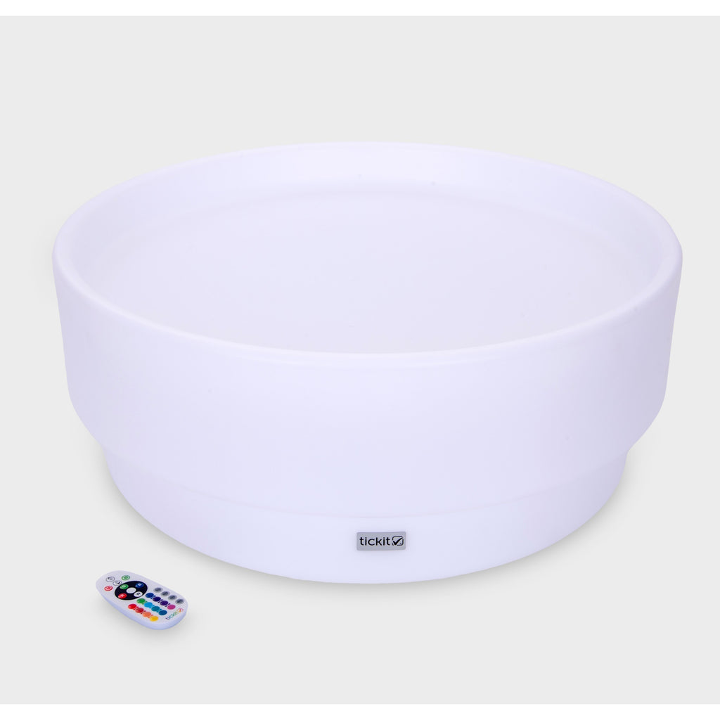 A softly glowing LED table with a shallow well, designed for sensory exploration, water play, and immersive learning experiences.