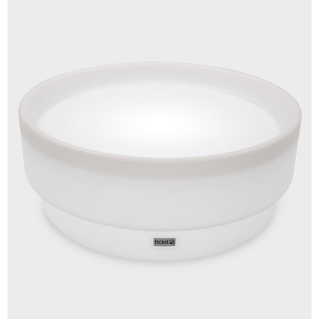 A softly glowing LED table with a shallow well, designed for sensory exploration, water play, and immersive learning experiences.