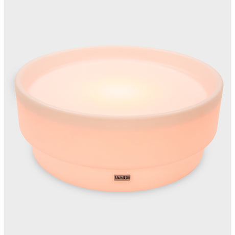 A softly glowing LED table with a shallow well, designed for sensory exploration, water play, and immersive learning experiences.