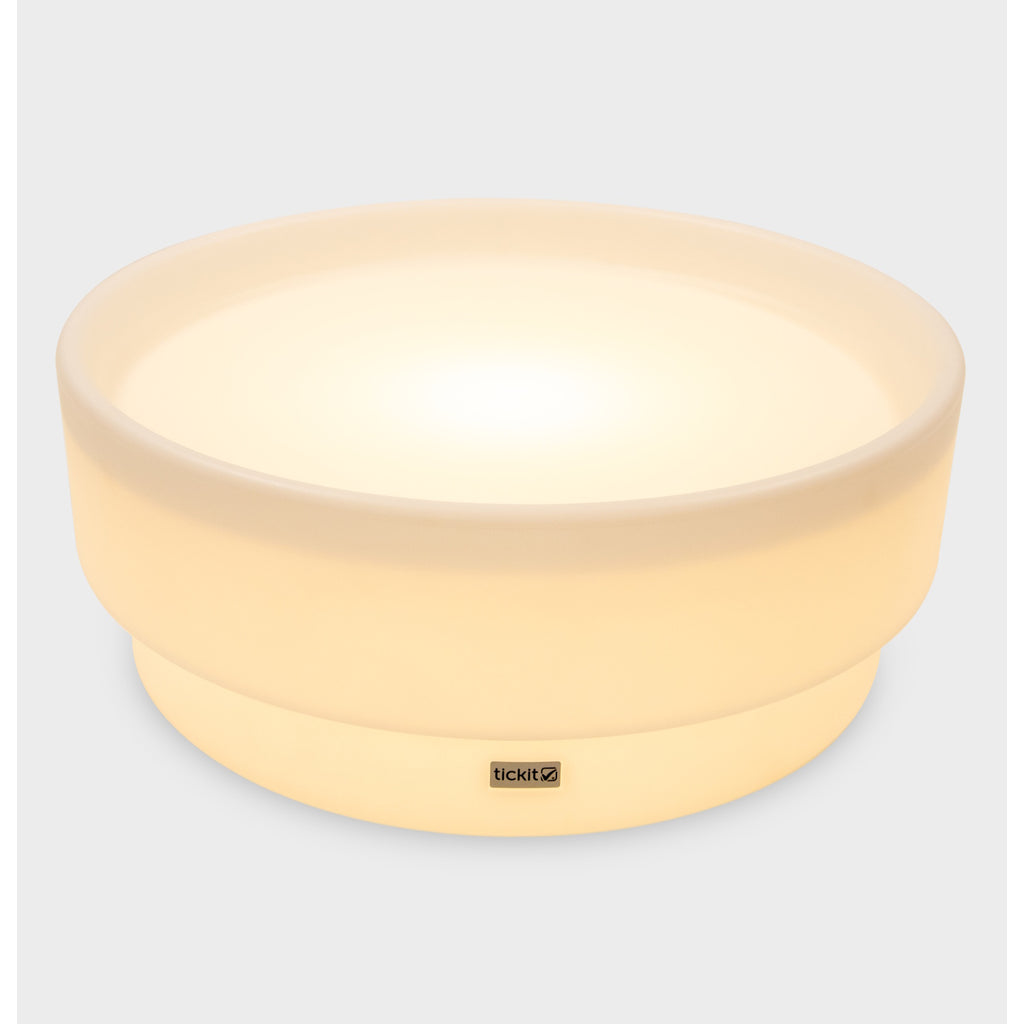 A softly glowing LED table with a shallow well, designed for sensory exploration, water play, and immersive learning experiences.