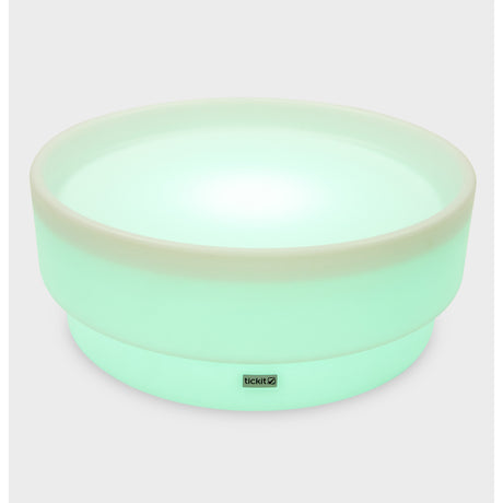 A softly glowing LED table with a shallow well, designed for sensory exploration, water play, and immersive learning experiences.