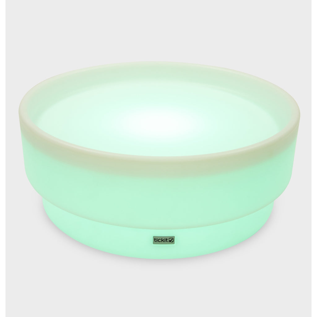 A softly glowing LED table with a shallow well, designed for sensory exploration, water play, and immersive learning experiences.