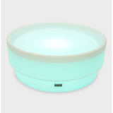 A softly glowing LED table with a shallow well, designed for sensory exploration, water play, and immersive learning experiences.