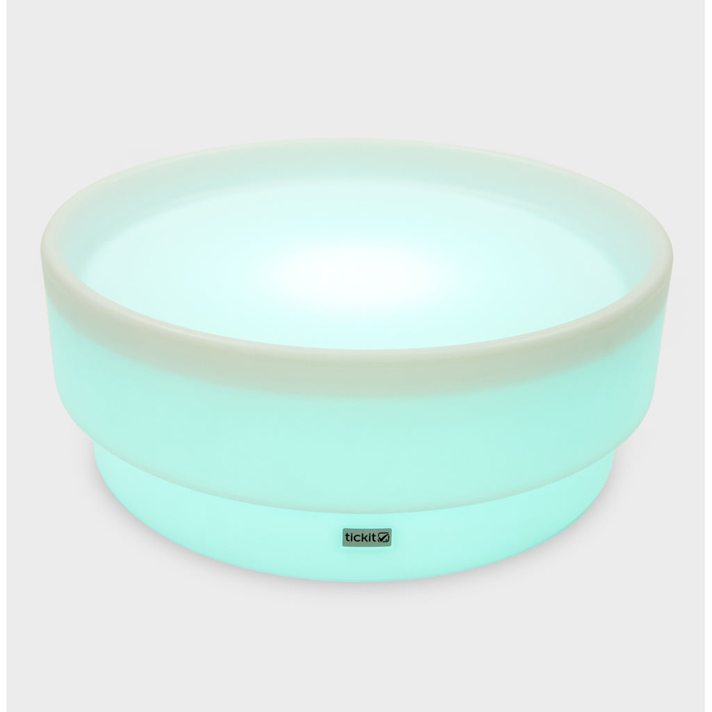 A softly glowing LED table with a shallow well, designed for sensory exploration, water play, and immersive learning experiences.