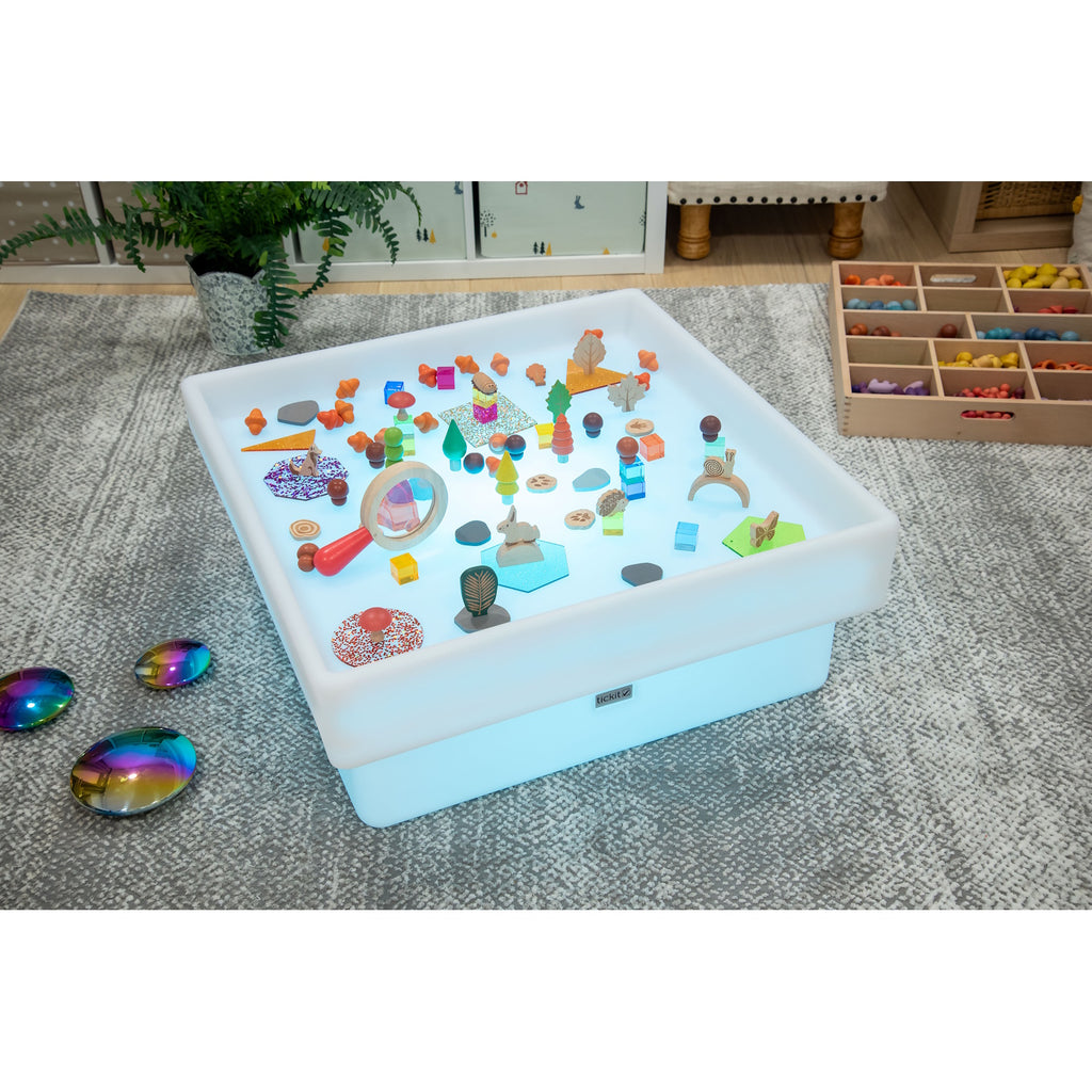 An illuminated square LED table with a raised edge, designed for sensory exploration, water play, and interactive learning.