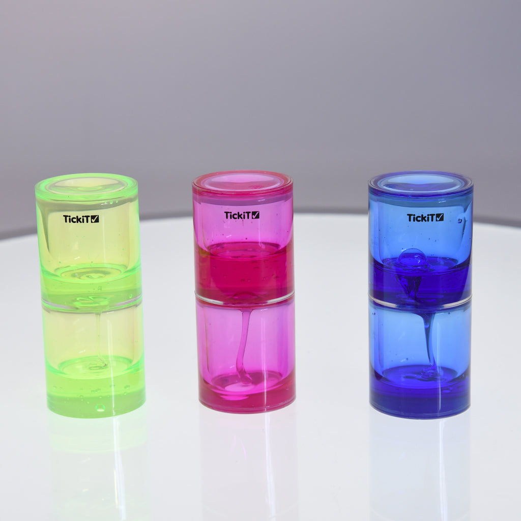 Three colorful liquid timers on a reflective surface: neon green, bright pink, and vivid blue. They convey a playful and dynamic mood.