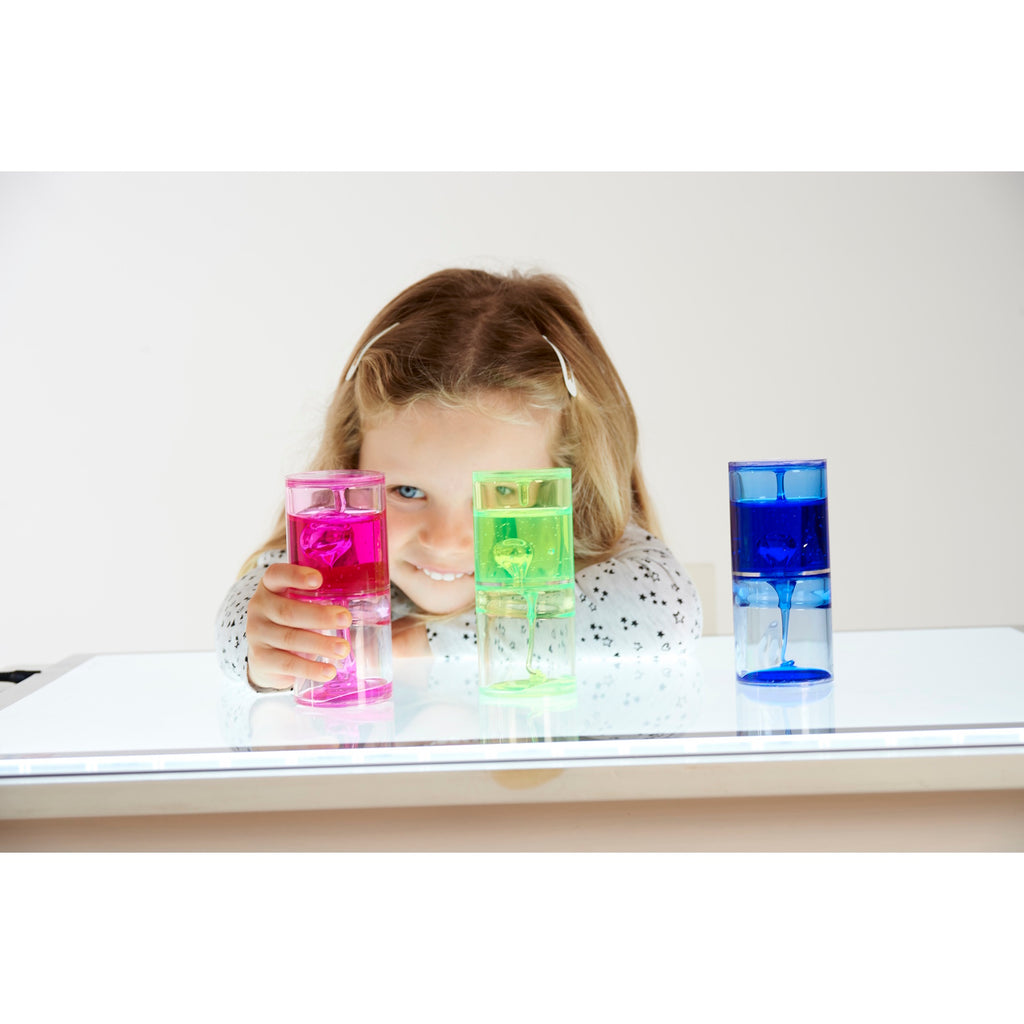 A trio of transparent tubes filled with slow-moving, colorful gel, designed to engage visual attention and support calming sensory play.