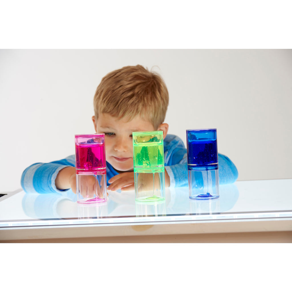 A trio of transparent tubes filled with slow-moving, colorful gel, designed to engage visual attention and support calming sensory play.