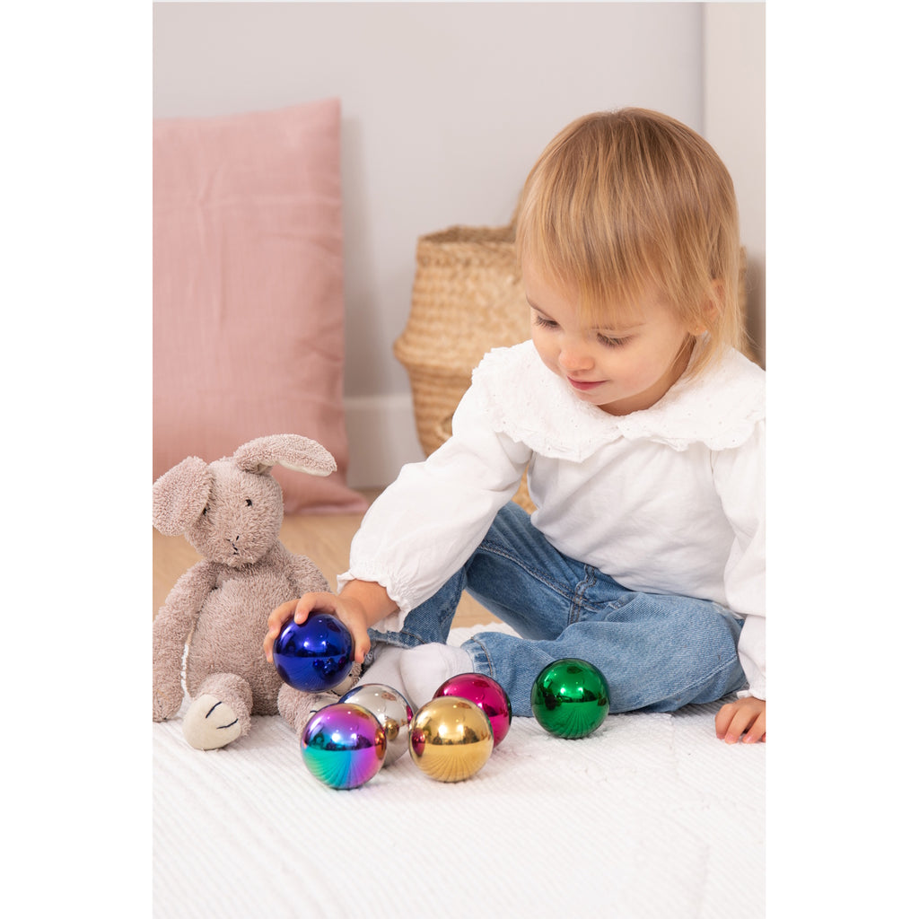 A set of colorful, reflective sensory balls that change appearance with movement, designed to engage children in tactile exploration and visual stimulation.