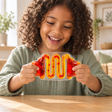 Front view of a child playing with a red-and-yellow liquid-filled sensory squeeze toy.