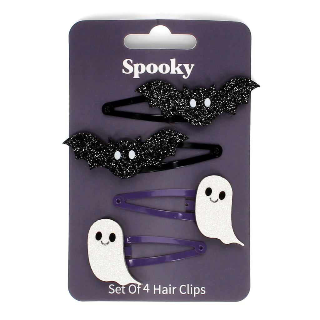Set of hair clips on a purple card labeled "Spooky." Includes two black glitter bat clips and two white ghost clips, each with playful expressions.