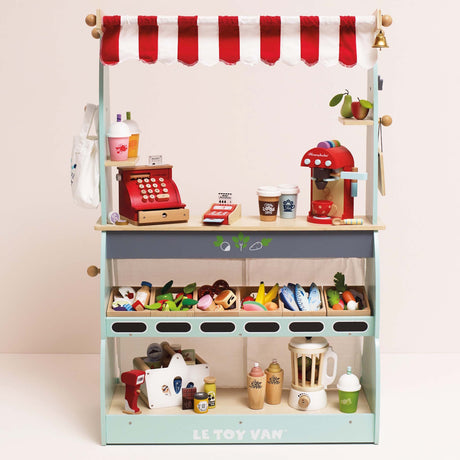 Wooden play market stall stocked with toy groceries, cash register, coffee maker, and play accessories.