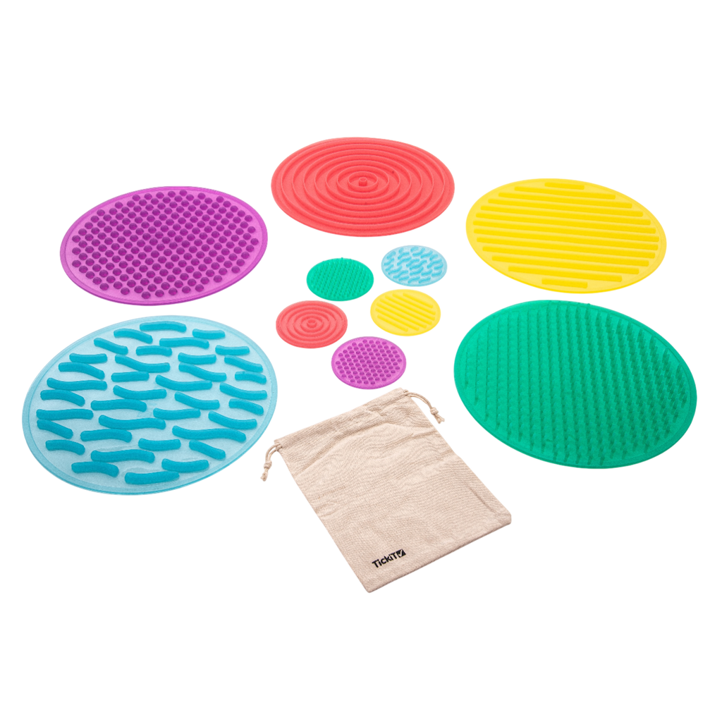 A set of textured silicone circles in various colors and patterns, designed to stimulate tactile exploration and sensory development in children.