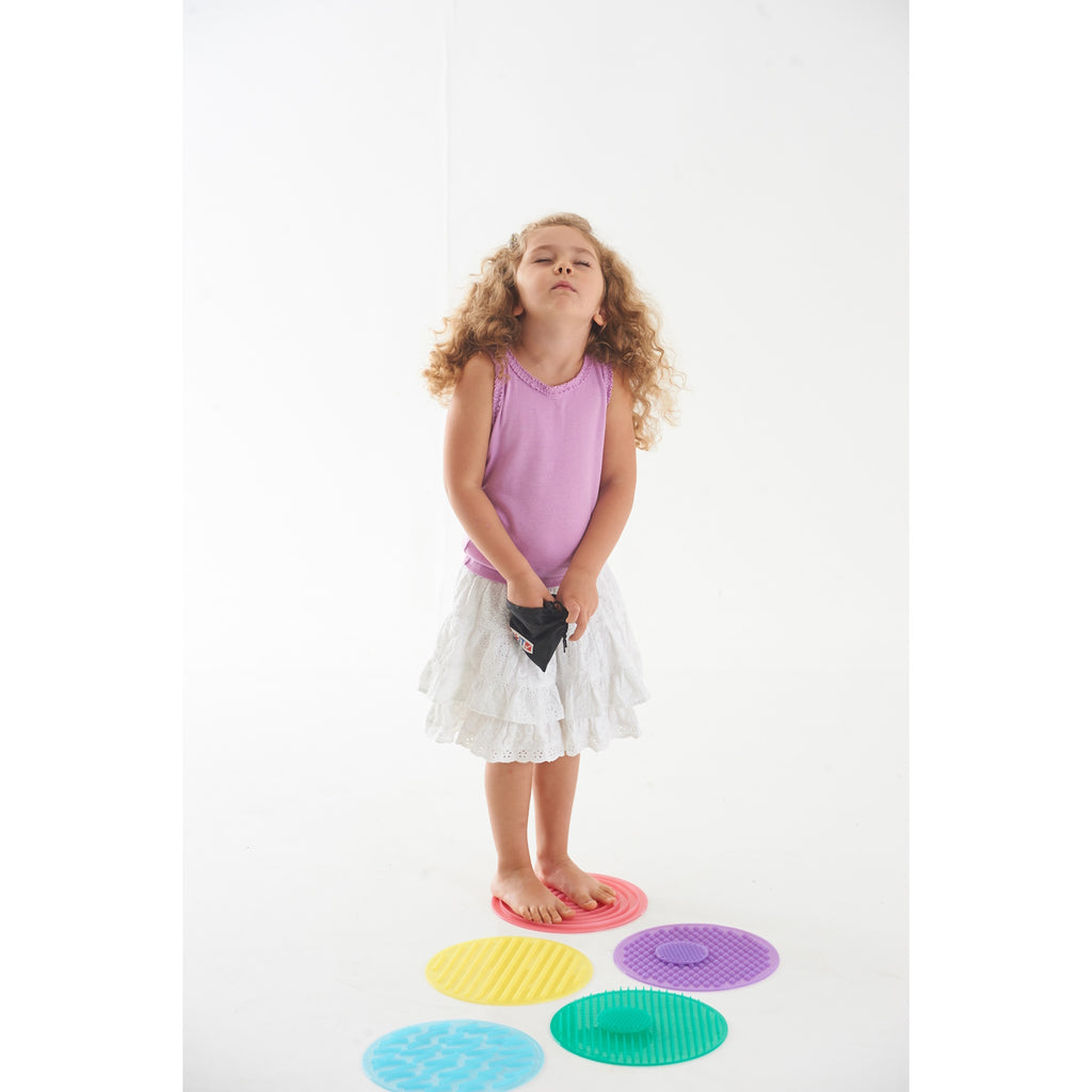 A set of textured silicone circles in various colors and patterns, designed to stimulate tactile exploration and sensory development in children.