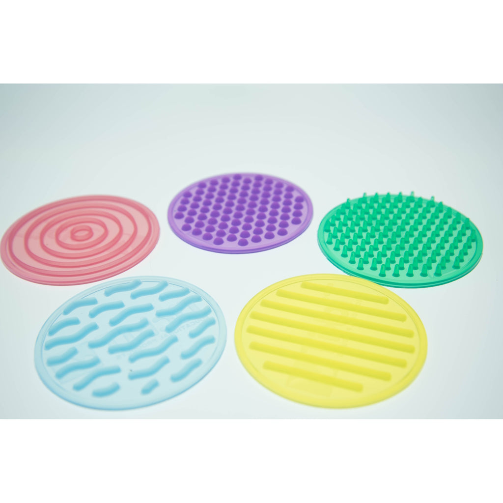 A set of textured silicone circles in various colors and patterns, designed to stimulate tactile exploration and sensory development in children.