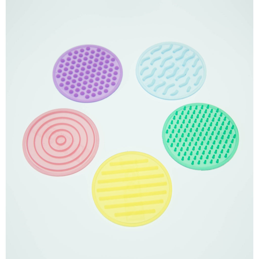 A set of textured silicone circles in various colors and patterns, designed to stimulate tactile exploration and sensory development in children.