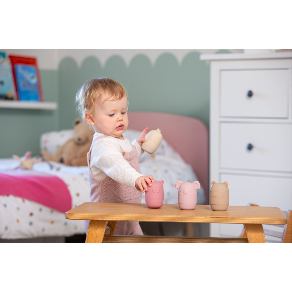 A set of soft silicone animal-shaped squirters in earthy tones, perfect for sensory play and water activities, designed for young children.