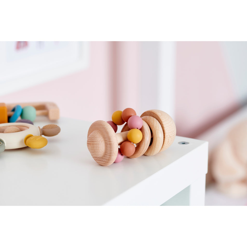 A soft silicone rattle featuring colorful beads in earthy tones, designed to stimulate sensory exploration and fine motor skills in babies.