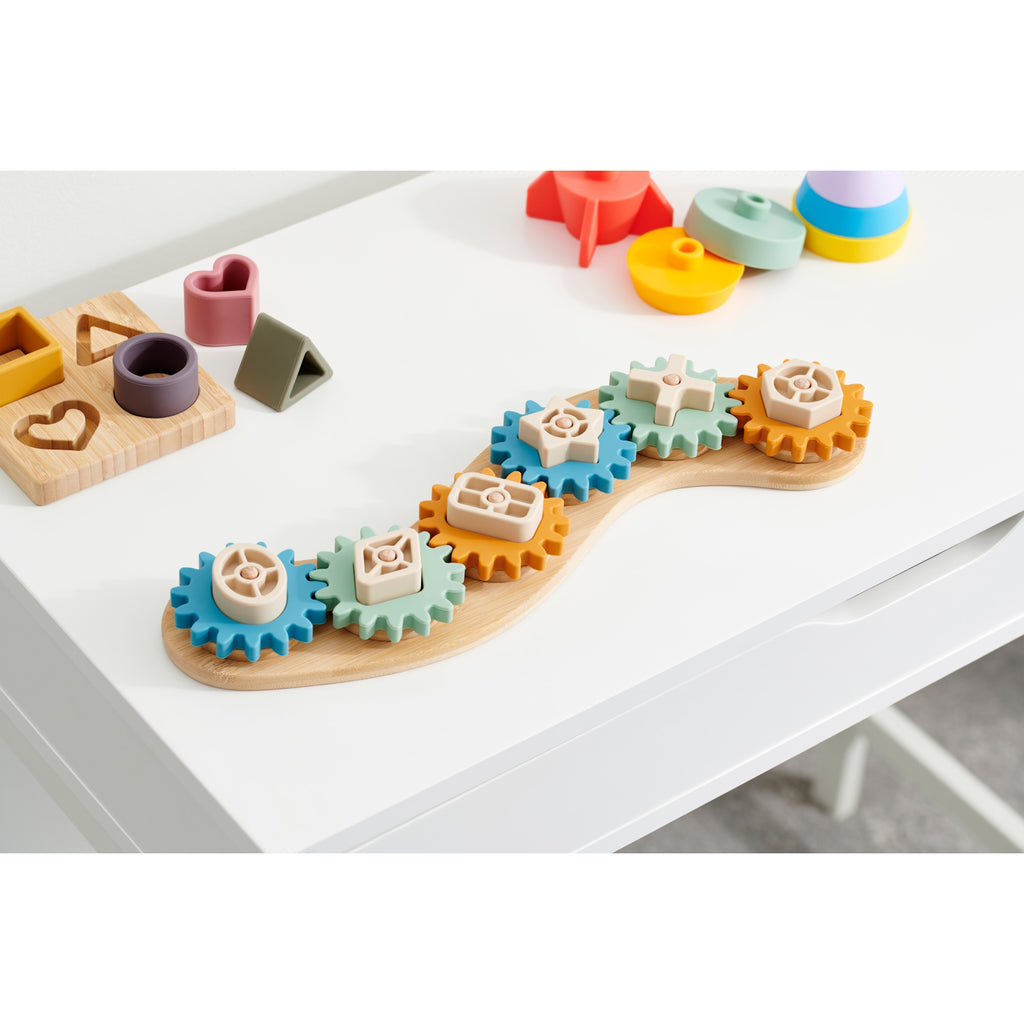 A soft silicone puzzle featuring interlocking gears in neutral tones, designed to promote sensory play and problem-solving skills.