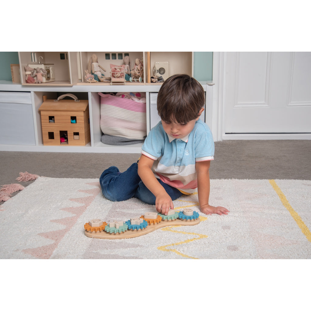 A soft silicone puzzle featuring interlocking gears in neutral tones, designed to promote sensory play and problem-solving skills.