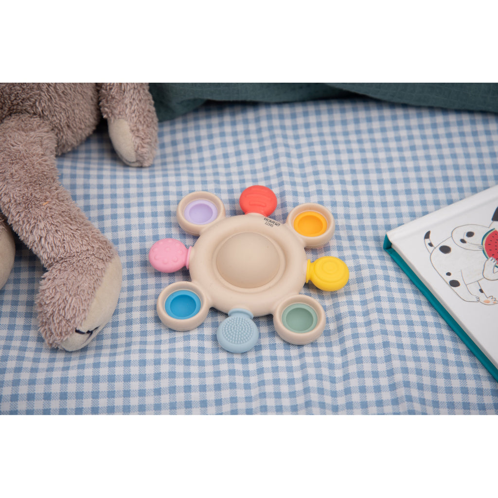 A vibrant silicone teether with popping textures, designed to soothe and engage babies while promoting sensory and tactile development.