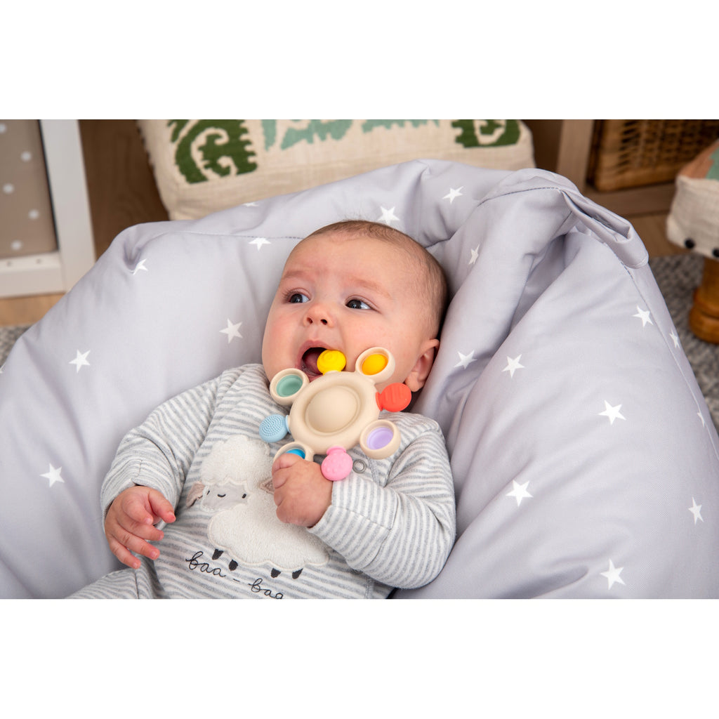 A vibrant silicone teether with popping textures, designed to soothe and engage babies while promoting sensory and tactile development.