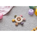 A soft silicone teether with a built-in rattle, designed in earthy tones to soothe and engage babies while promoting sensory development.
