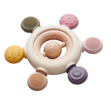 A soft silicone teether with a built-in rattle, designed in earthy tones to soothe and engage babies while promoting sensory development.