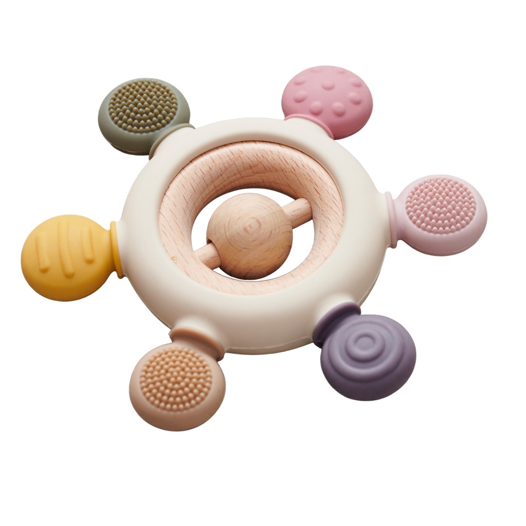 A soft silicone teether with a built-in rattle, designed in earthy tones to soothe and engage babies while promoting sensory development.