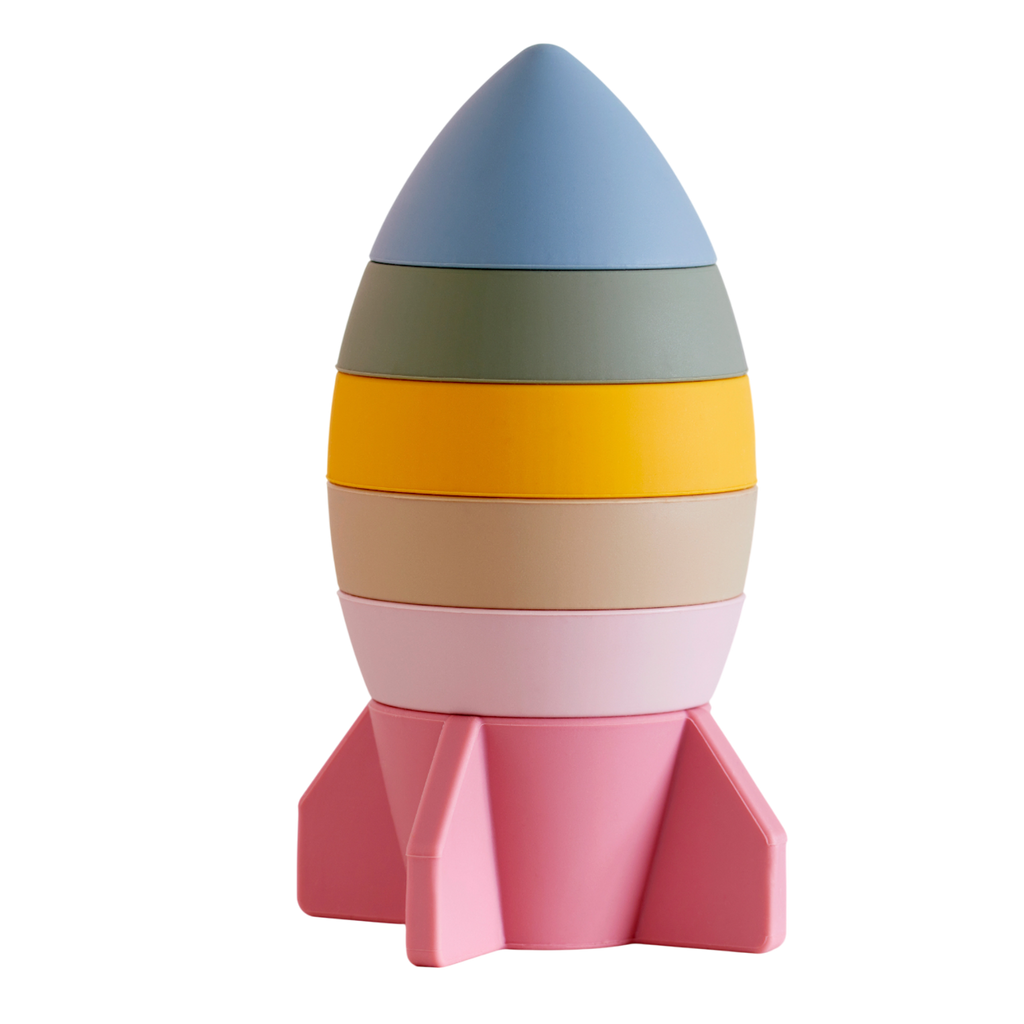 A soft silicone stacking toy in earthy tones, shaped like a rocket, designed to encourage sensory exploration and fine motor skills.