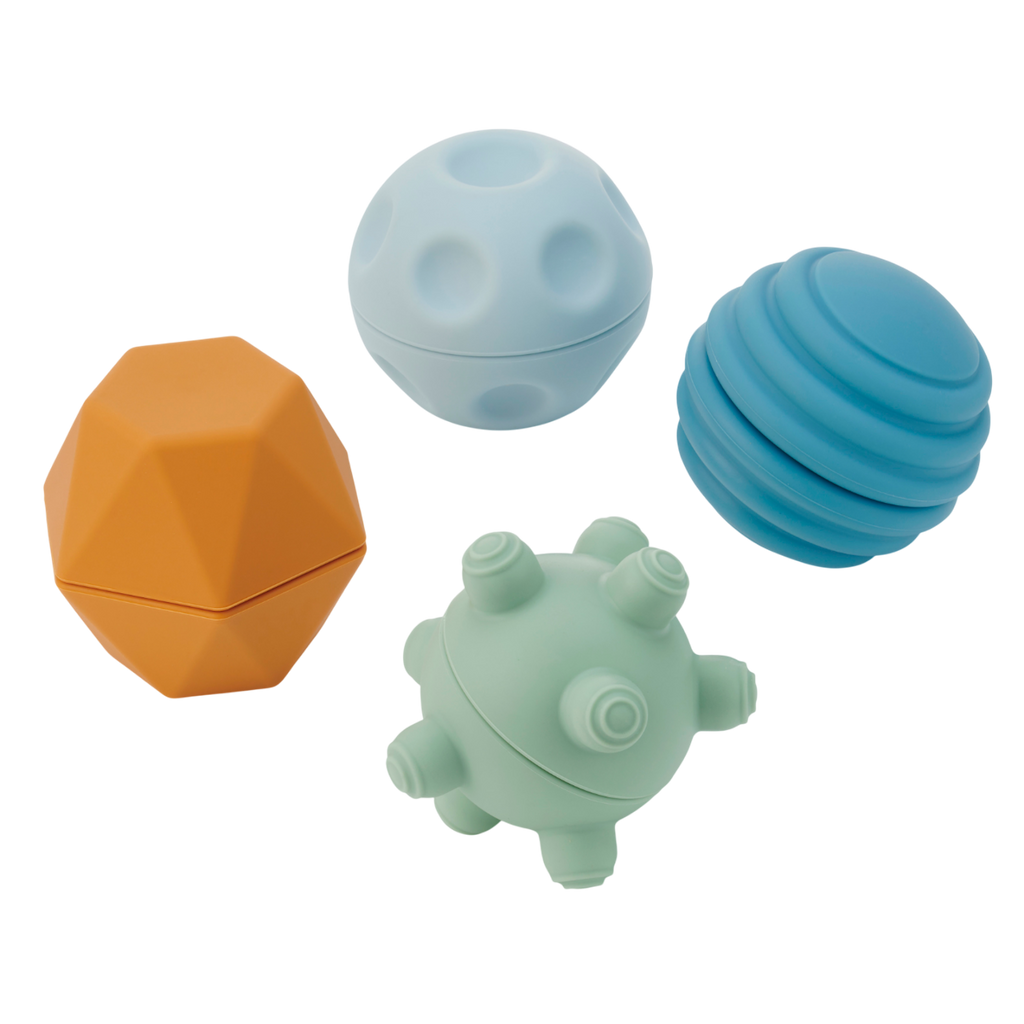 A set of soft silicone balls in neutral tones, featuring a textured surface to encourage tactile exploration and sensory development in young children.