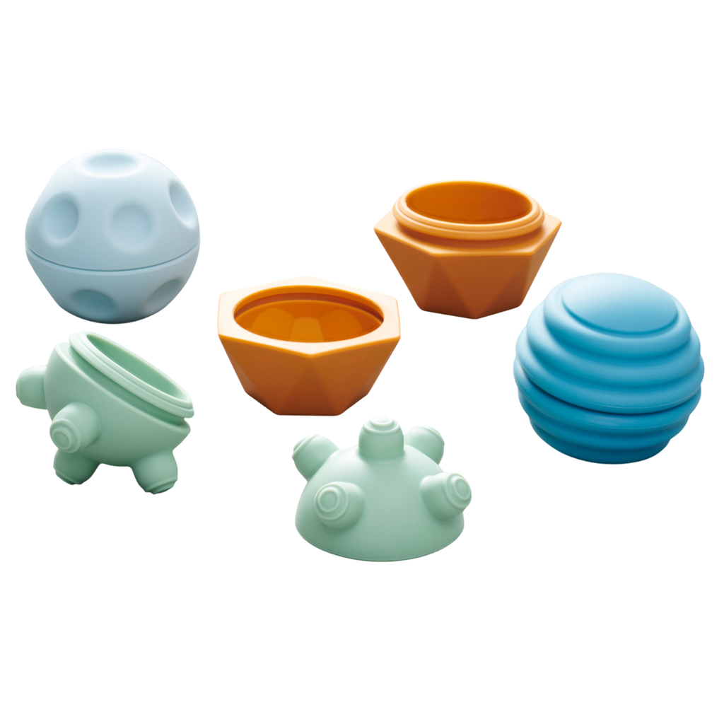 A set of soft silicone balls in neutral tones, featuring a textured surface to encourage tactile exploration and sensory development in young children.
