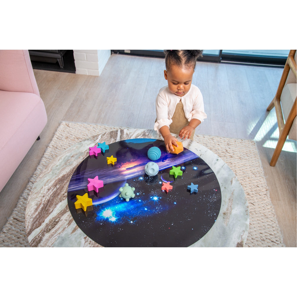A set of soft silicone balls in neutral tones, featuring a textured surface to encourage tactile exploration and sensory development in young children.
