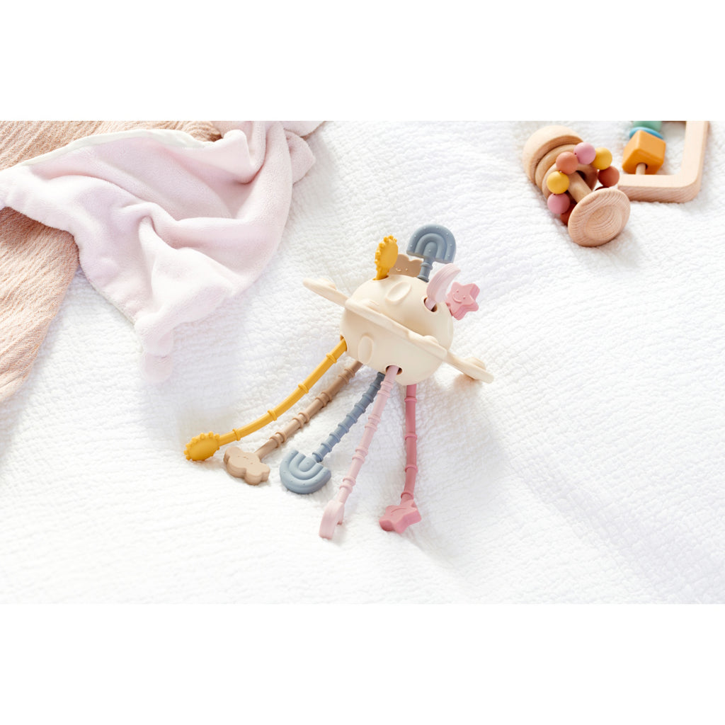 A soft silicone pull toy in earthy tones with textured zip-like ridges, designed to enhance sensory exploration and fine motor skills in young children.