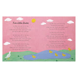 Inside page of nursery rhyme book "Five Little Ducks" with embroidered ducks, pond, and hills on a pink background.