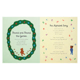 Children's book page featuring "The Alphabet Song" and "Round and Round the Garden" with a teddy bear and colorful letters.