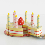 Wooden sliceable toy birthday cake with candles and strawberry.