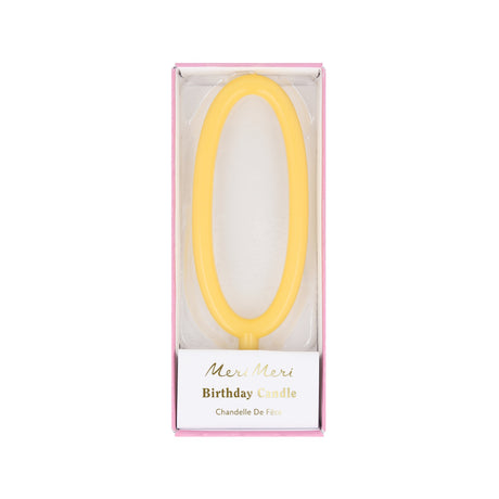 Yellow slim number 0 birthday candle packaged in a clear box by Meri Meri.